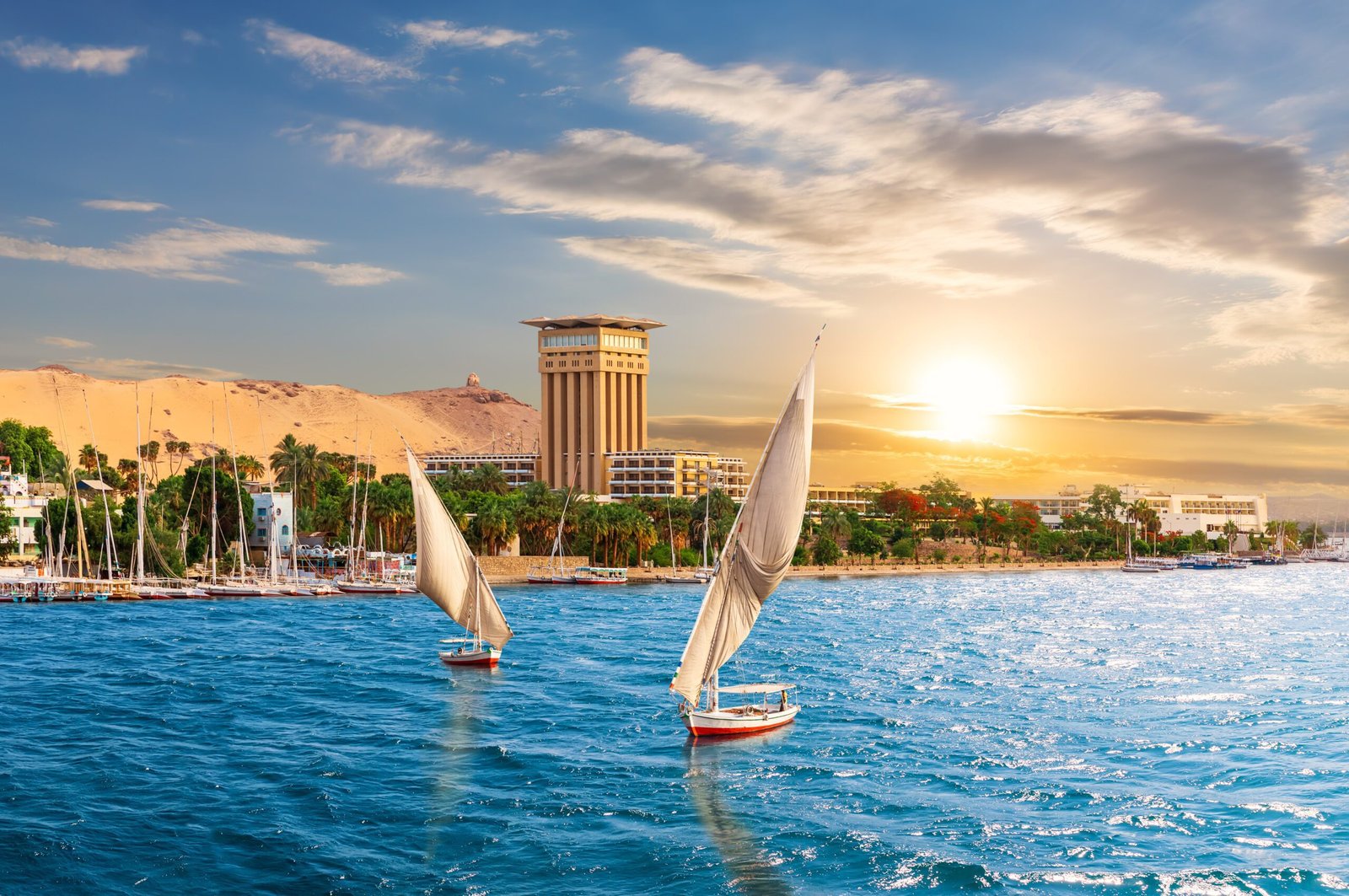 Aswan sunset scenery, view of the Nile and traditional boats, Egypt